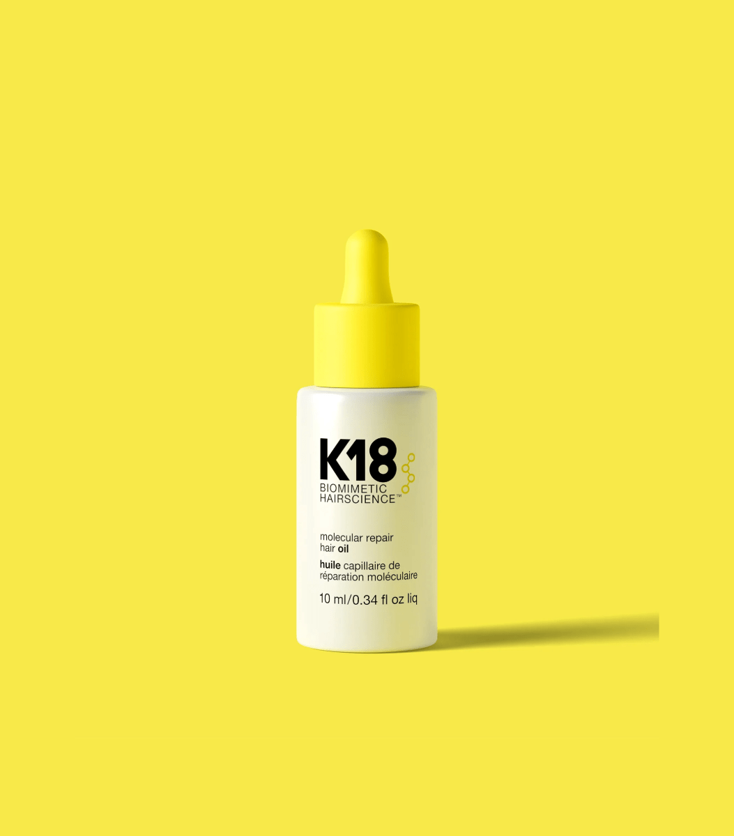 K18 Molecular Repair Hair Oil in a yellow bottle, designed for damage repair and frizz control, 10 ml size.