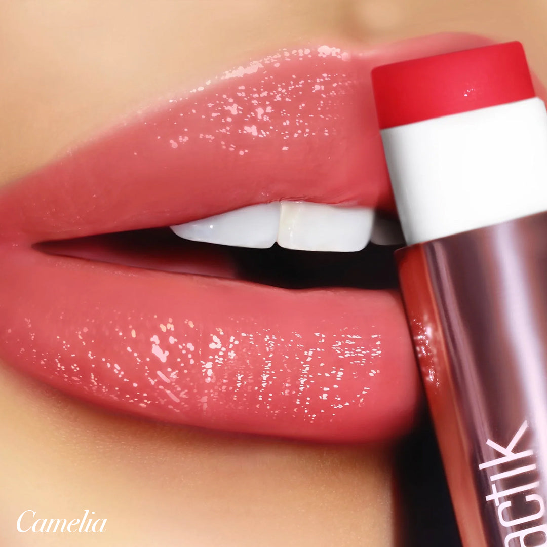 Close-up of glossy lips wearing Girlactik Jello Gloss Balm in Camelia, showcasing a pink lemonade shine and smooth finish.