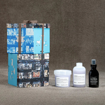 Davines Love Smoothing Oi Gift Set with shampoo, conditioner, and leave-in milk for frizz control and smooth hair.