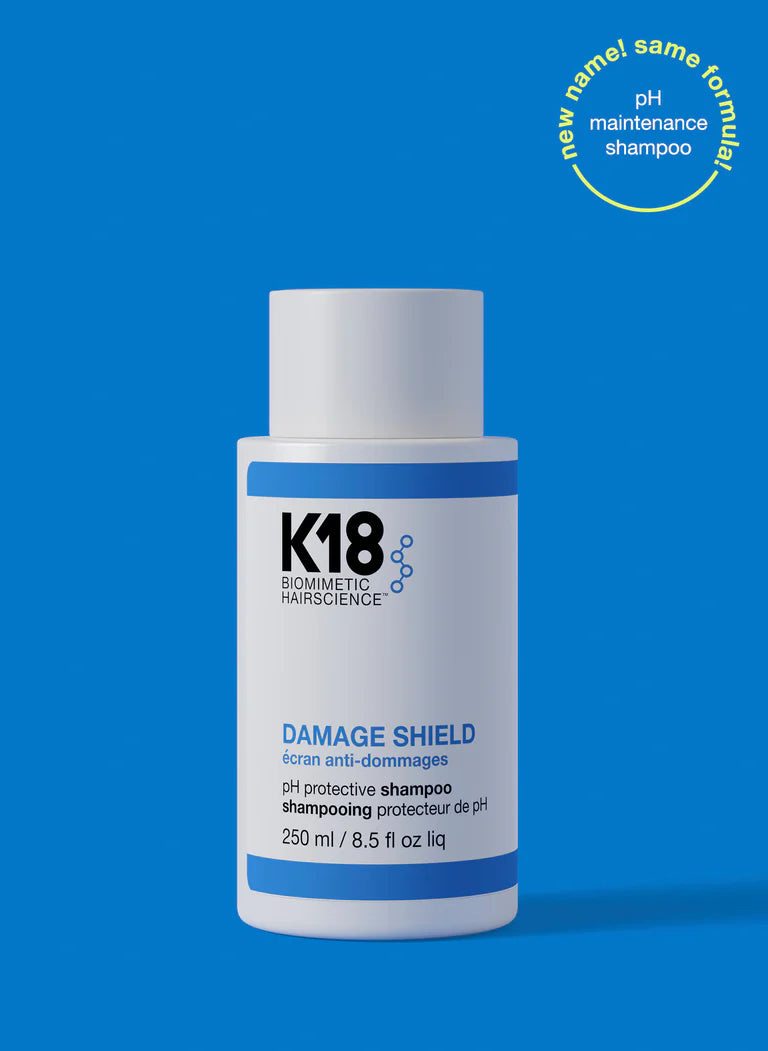 K18 DAMAGE SHIELD pH Protective Shampoo bottle on blue background, promoting healthy and color-safe hair care.