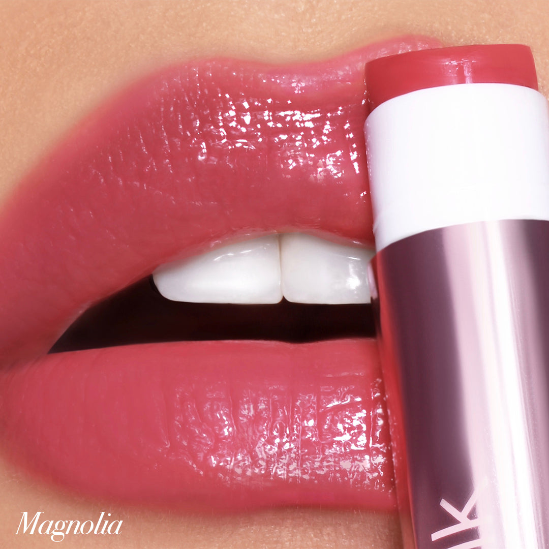 Close-up of lips with glossy Jello Gloss Balm in Magnolia, showcasing smooth hydration and a pink lemonade scent.