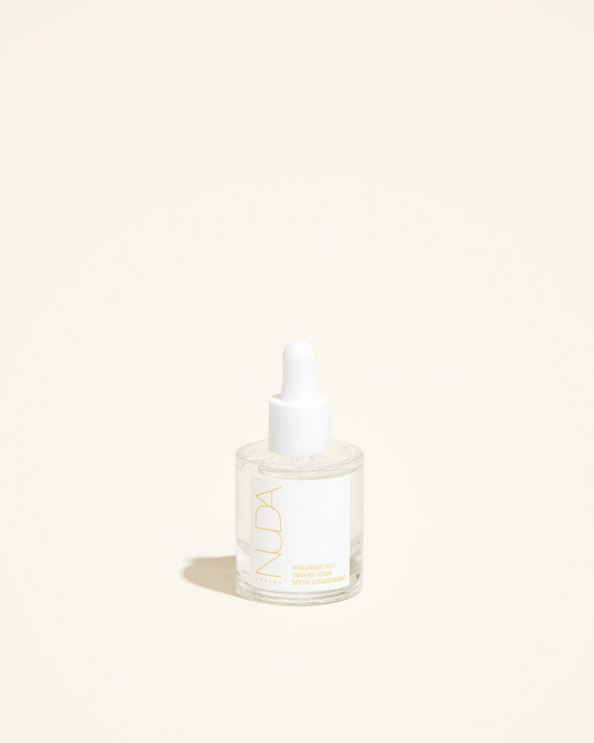 Hyaluronic Self Tanning Serum in a glass bottle with dropper, promoting radiant skin and hydration.