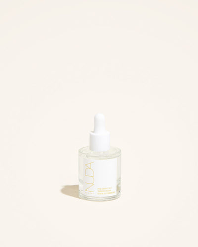 Hyaluronic Self Tanning Serum in a glass bottle with dropper, promoting radiant skin and hydration.