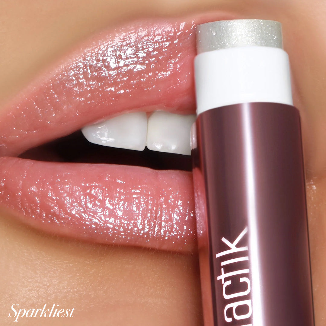 Sparkliest Jello Gloss Balm applied on lips, showcasing glossy shine and nourishing formula with pink lemonade scent.