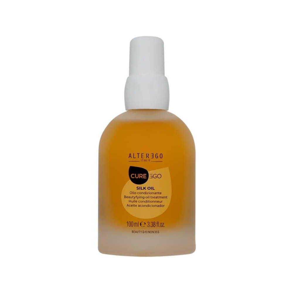 Silk Oil Blend Oil in a clear bottle, formulated for unruly, frizzy hair, providing shine and nourishment.