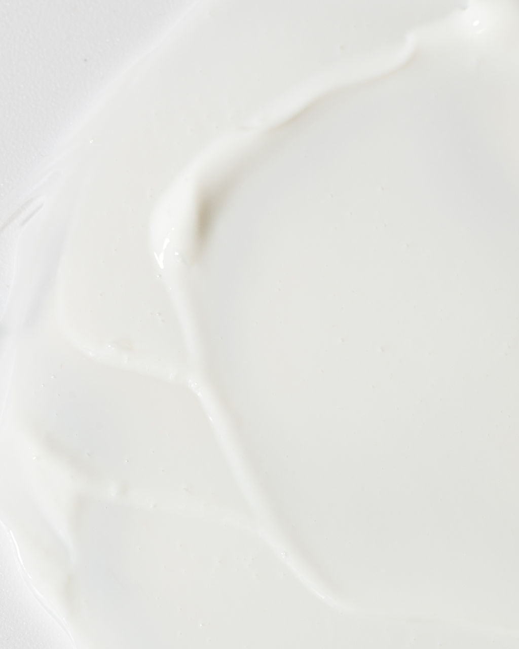 Close-up of creamy Age-Defying Body Lotion, highlighting its smooth texture and hydrating formula.