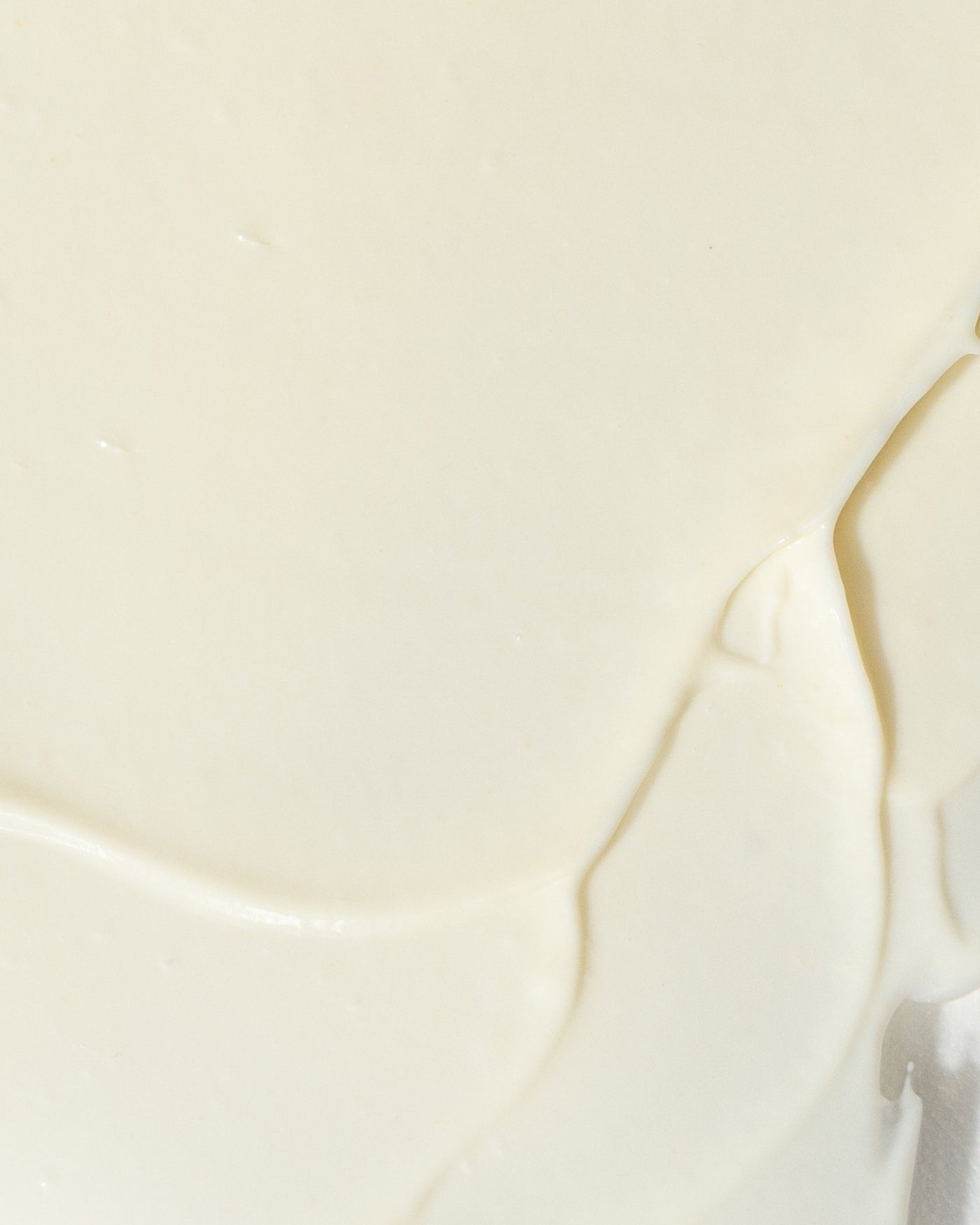 Close-up of creamy texture of GrenzCine Neck growth factor neck cream.