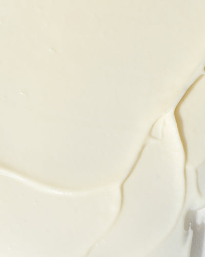 Close-up of creamy texture of GrenzCine Neck growth factor neck cream.