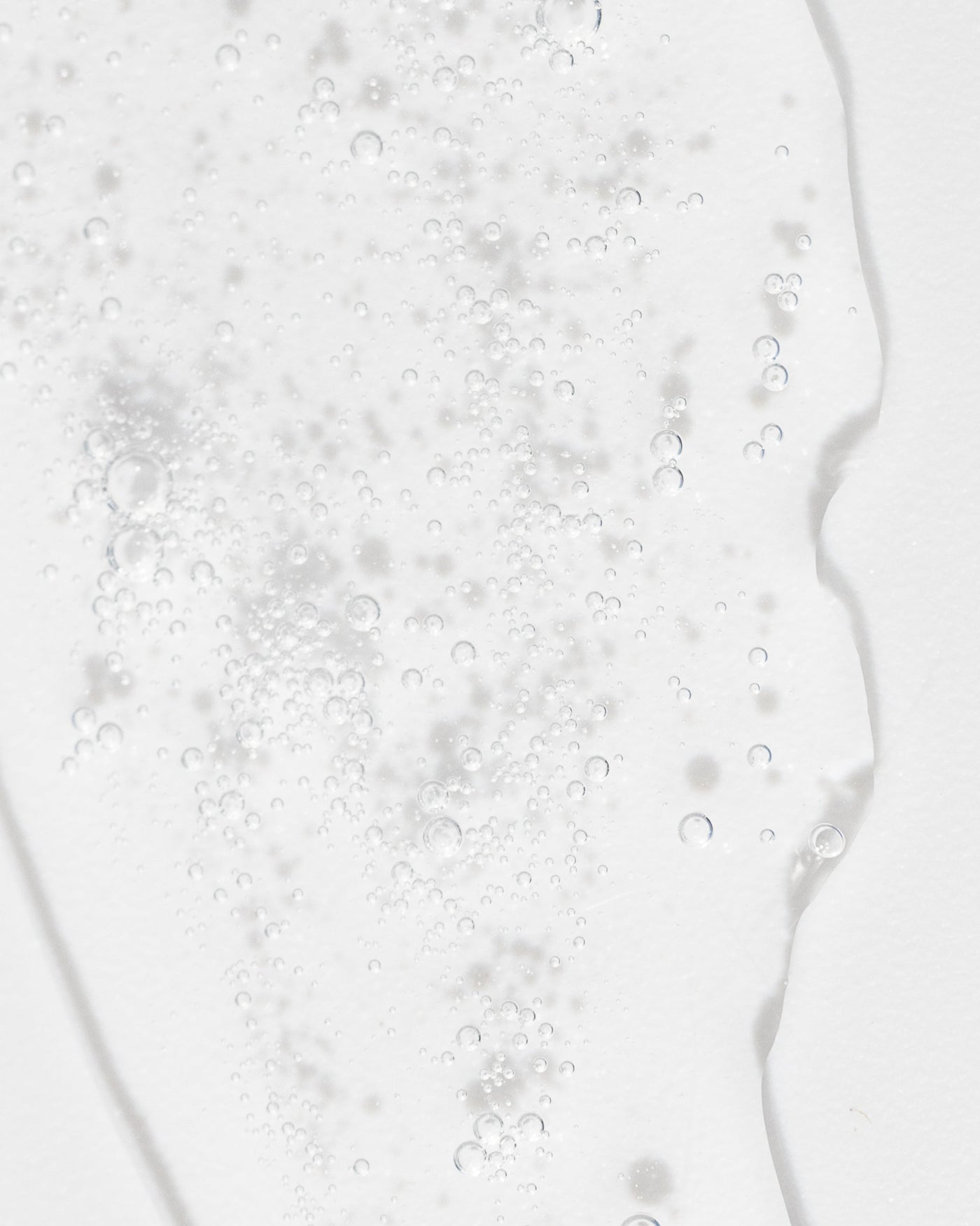 Close-up of refreshing toner texture with bubbles, showcasing its gentle, hydrating properties for skin care.