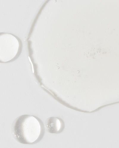 clear serum droplets on a white background, showcasing a lightweight texture ideal for all skin types.