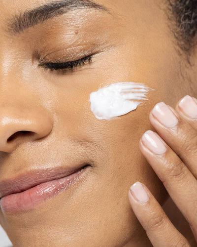 Woman applying Skin Brightening Cream, showing a smooth texture and glowing skin tone. Suitable for all skin types.