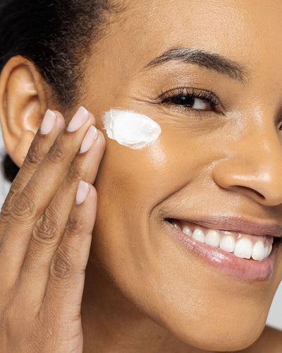 Woman applying Vivier Ultra Hydrating Mask to her face, showcasing smooth and hydrated skin.