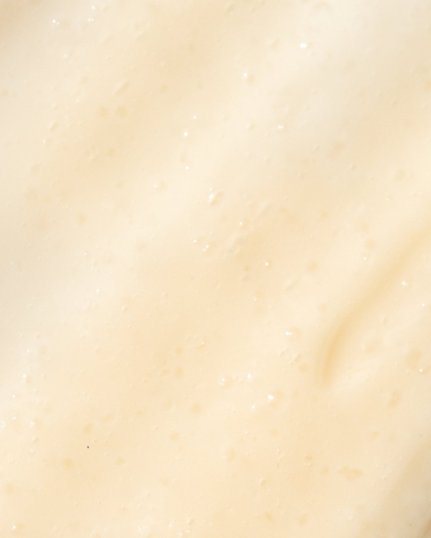 Close-up of creamy texture of Vivier Vitamin C Scrub, highlighting smooth biodegradable beads for gentle exfoliation.