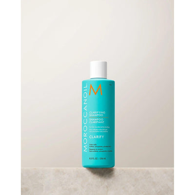 Moroccanoil Clarifying Shampoo bottle on a neutral background, designed to remove buildup and restore hair balance.