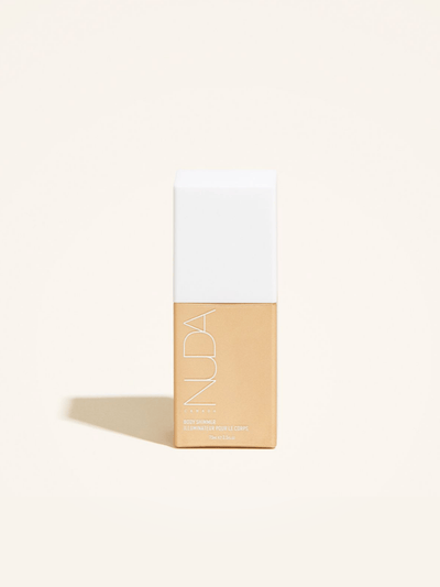 Body Shimmer bottle by Nuda, featuring a sleek design with a white cap and golden illuminator for radiant skin.