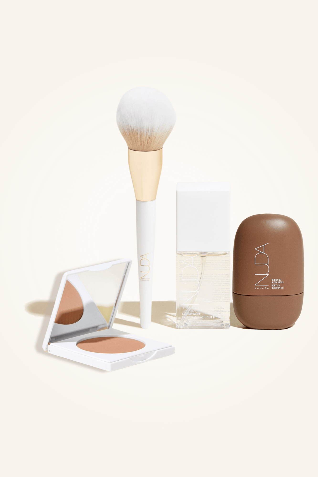 Deluxe Bronzed Kit featuring facial tanner, bronzing powder, brush, and shimmer for a radiant complexion.