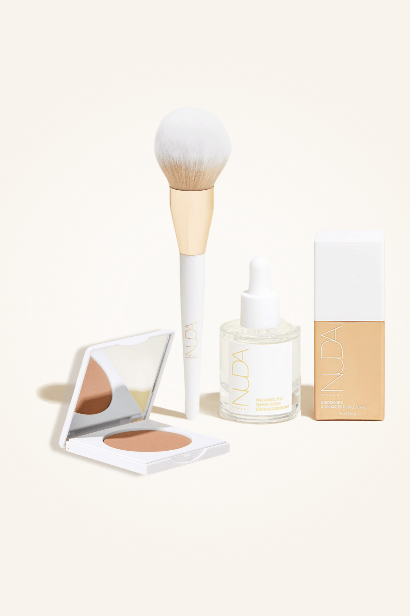 Deluxe Bronzed Trio featuring facial self tanner, bronzing powder, brush, and glow drops for a radiant tan.