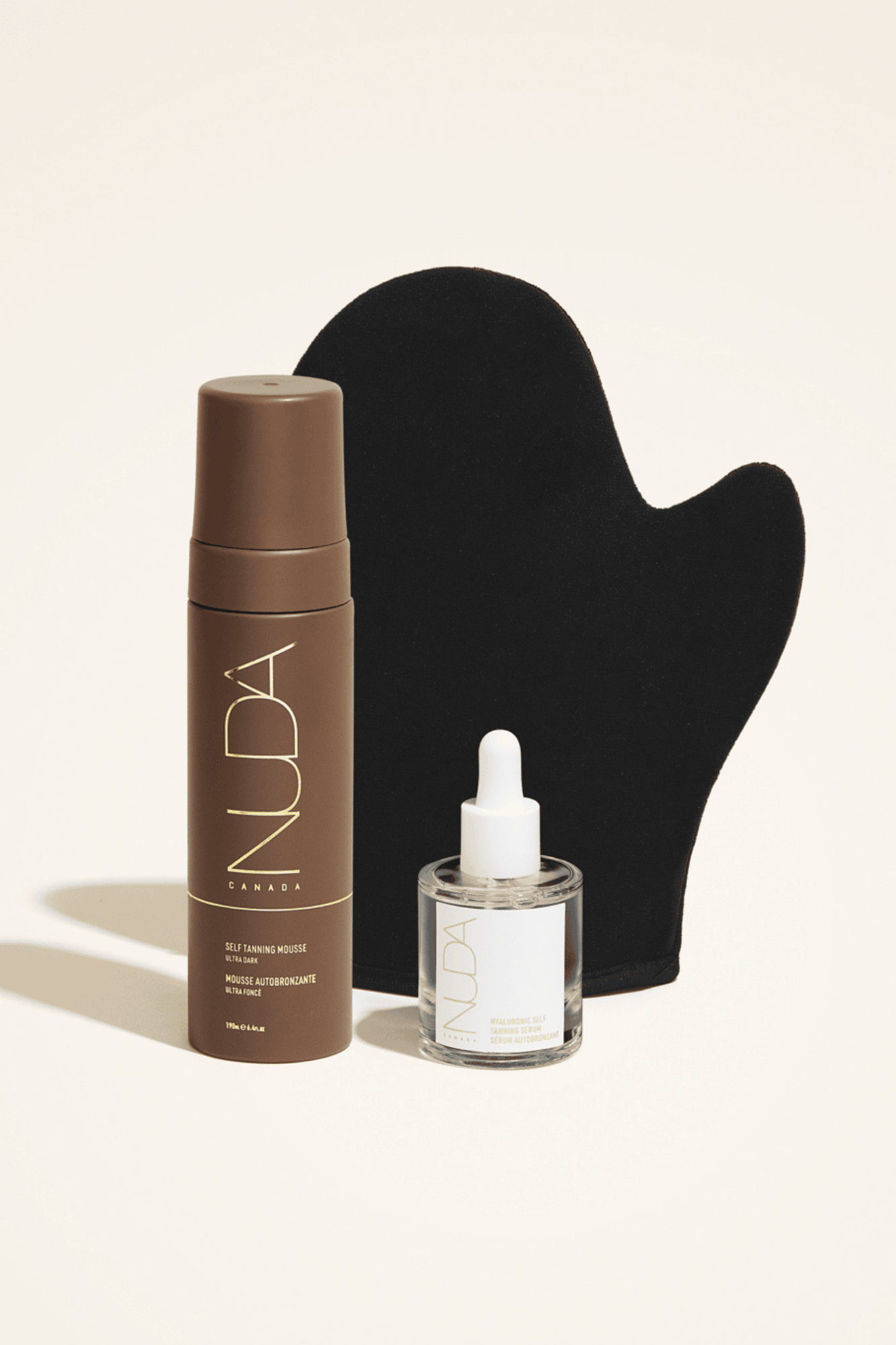 Nuda Glow Kit featuring self tanning mousse, tanning mitt, and facial self tanner for a customized golden tan.