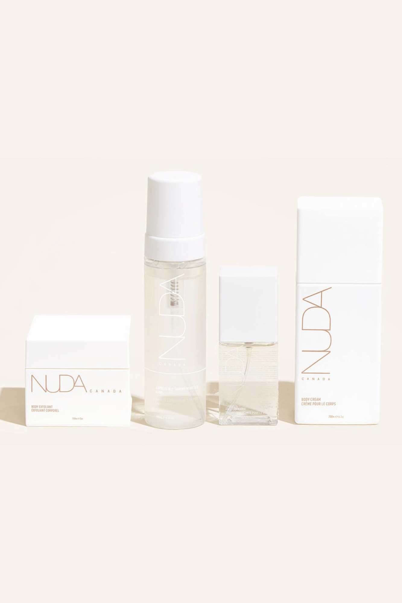 Nuda Routine Kit featuring Body Exfoliant, Self Tanning Mousse, face tanner, and Body Cream in elegant packaging.