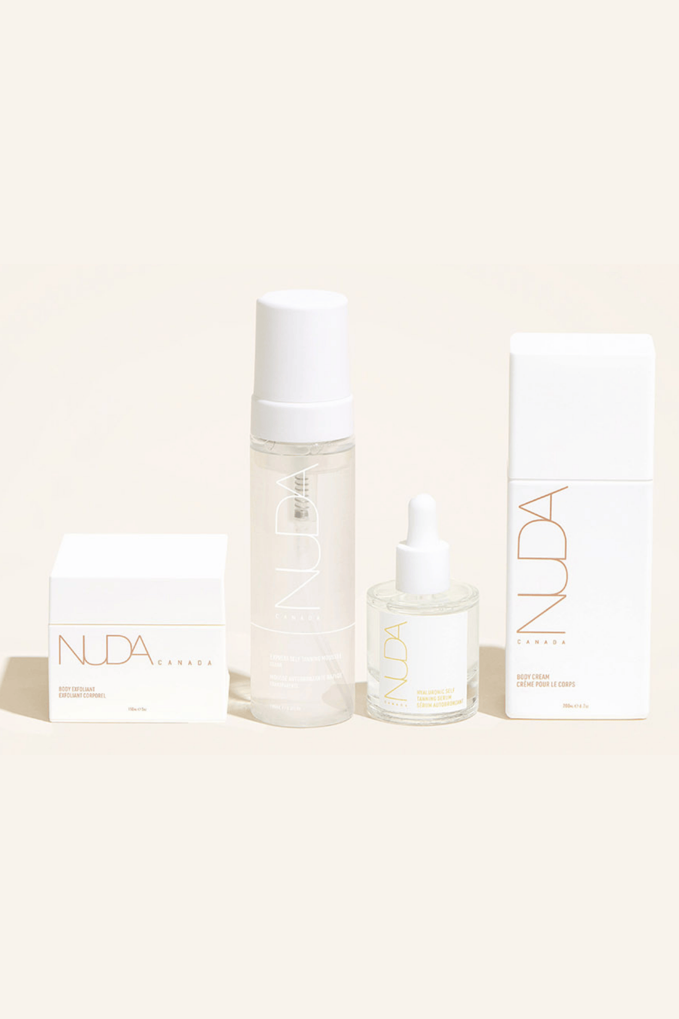 Nuda Routine Kit featuring body exfoliant, self tanning mousse, face tanner, and body cream for a flawless tan.