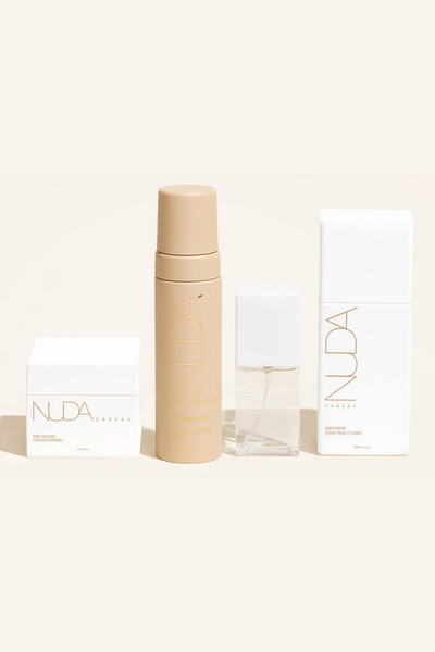 Nuda Routine Kit featuring a body exfoliant, self tanning mousse, face tanner, and nourishing body cream.