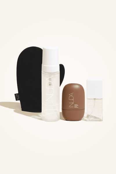 Ultimate Glow Kit featuring self tanning mousse, facial tanner, and tanning mitt for a flawless glow.