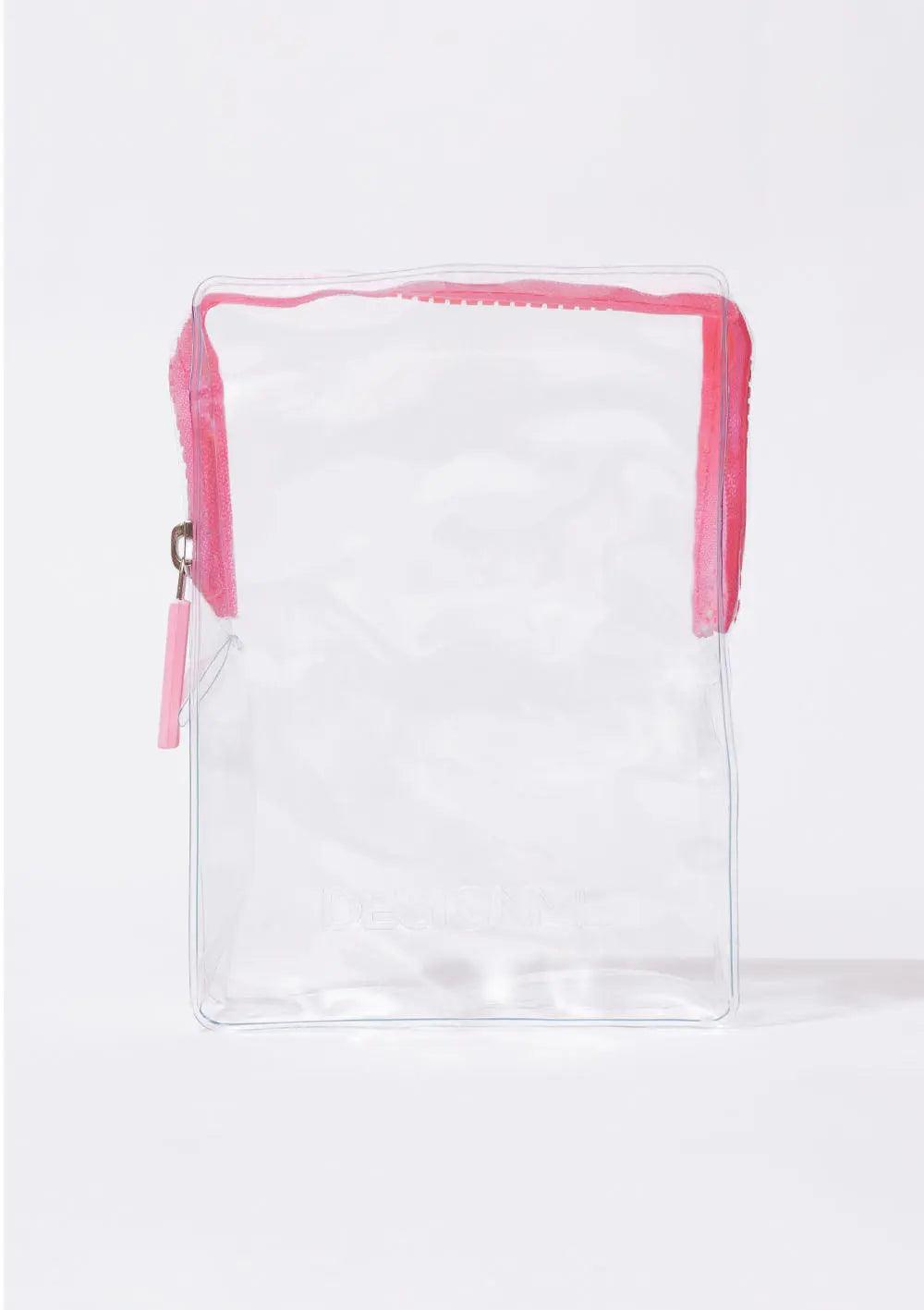 Clear cosmetic bag with pink zipper, perfect for storing hair products and styling essentials.