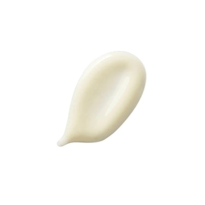 Close-up of white creamy lotion swatch, moisturizing cream texture.