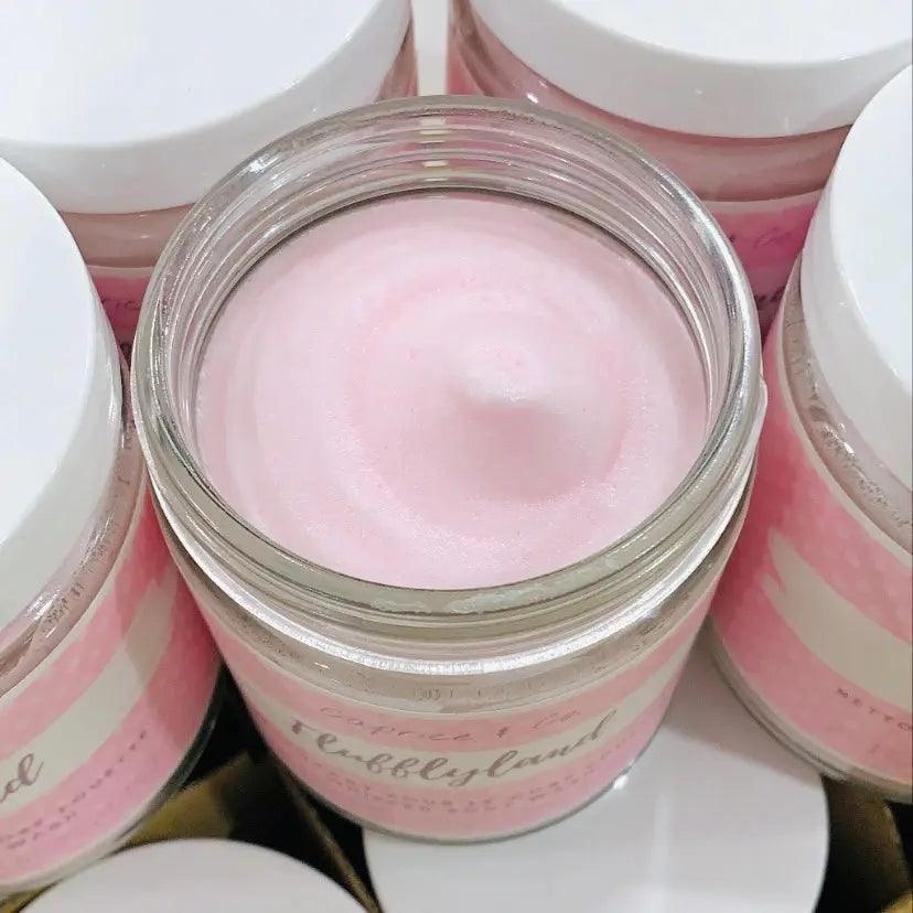 Pink whipped soap in clear jar, showcasing luxurious texture, perfect for moisturizing and sensitive skin care.